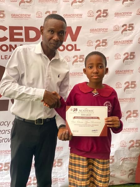 A Gracedew student shaking hands with a teacher at the awards ceremony