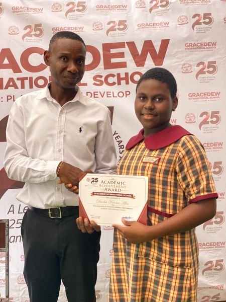 A Gracedew student receiving an achievement certificate