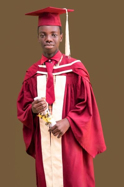 A Gracedew graduate holding a rolled certificate
