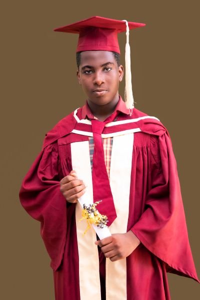 A Gracedew graduate in maroon cap and gown