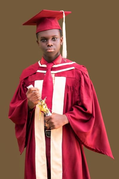 A Gracedew graduate in cap and gown with certificate